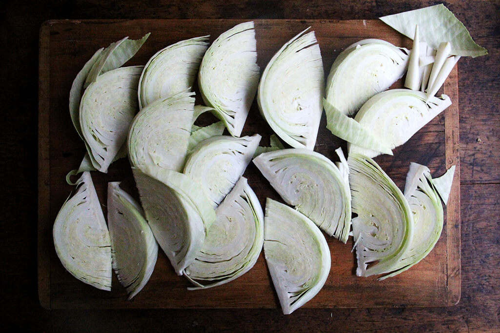 A board of cut cabbage wedges.