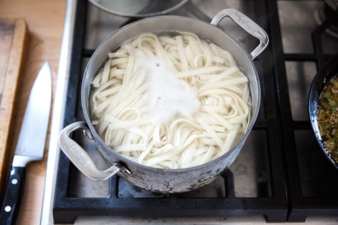 How to make Chinese noodles with chilies, scallions, and cabbage.