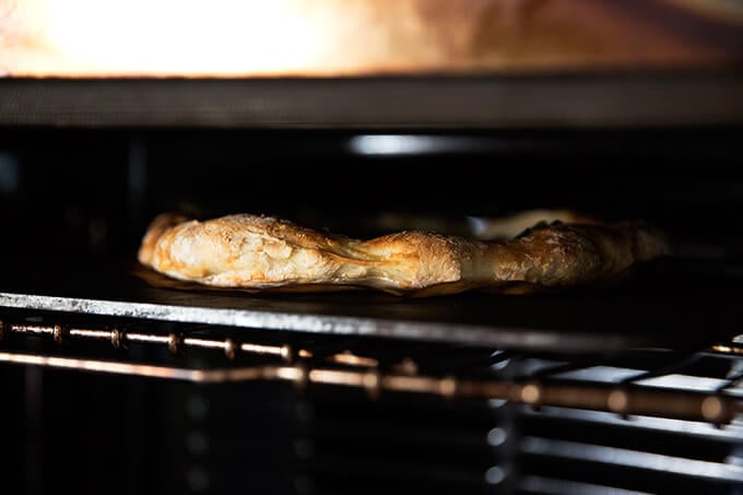 A homemade pizza baking on a Baking Steel in the oven. 