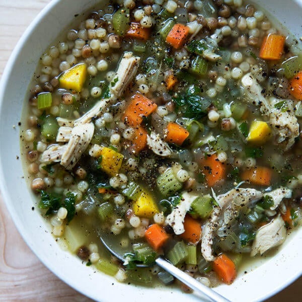 A bowl of simple, homemade chicken soup with fregola.