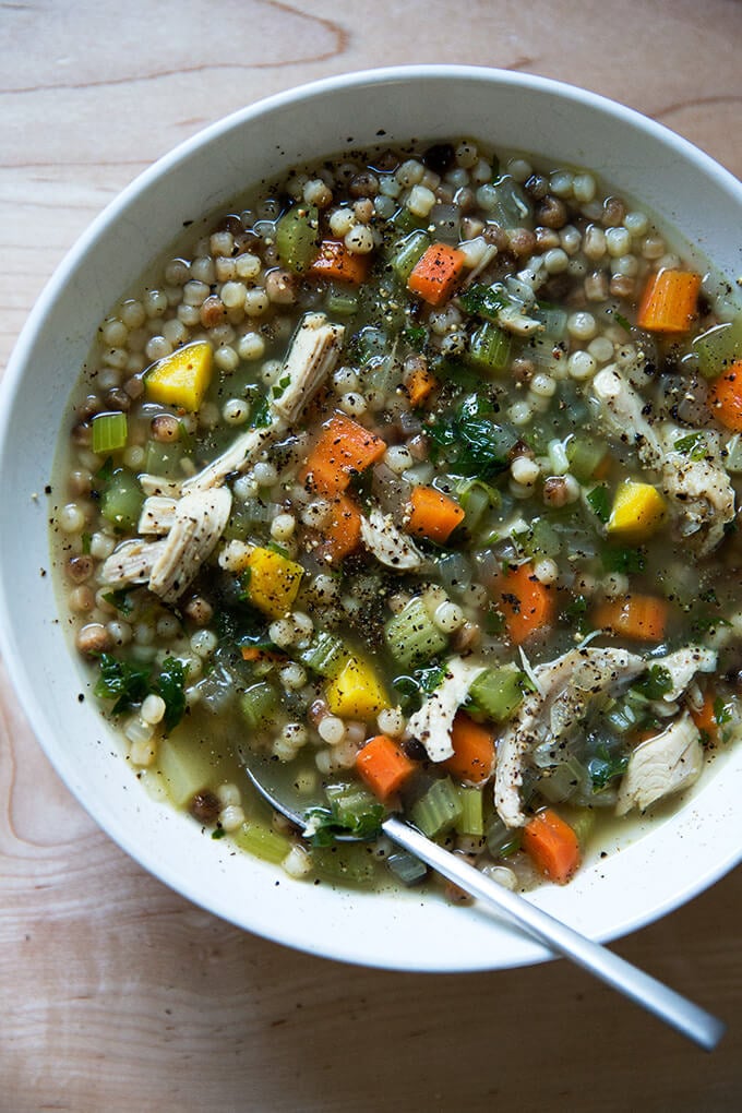 A bowl of simple, homemade chicken soup with fregola.