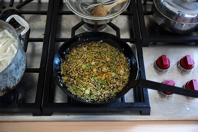 How to make Chinese noodles with chilies, scallions, and cabbage.