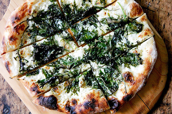 Just baked kale and creme fraiche pizza on a peel. 