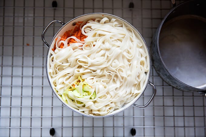 How to make Chinese noodles with chilies, scallions, and cabbage.