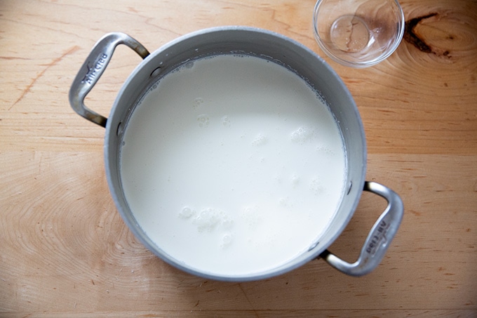 A pot filled with whole milk, heavy cream, and salt. 