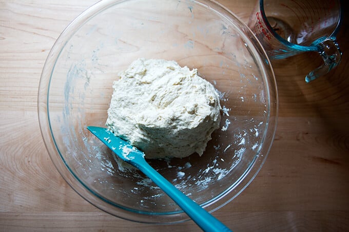 A bowl filled with just-mixed homemade pizza dough.