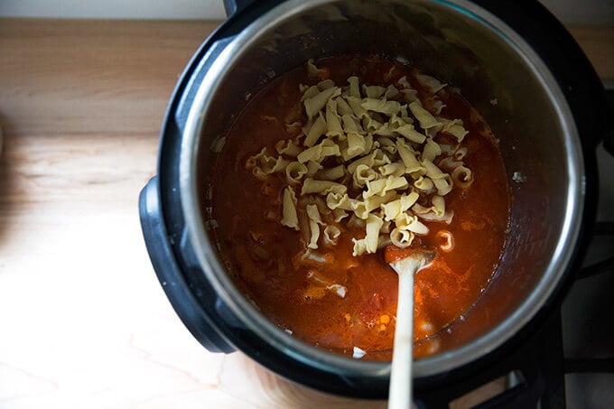 adding pasta and sauce to Instant Pot