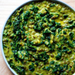 A bowl of curried lentils with kale and coconut milk.