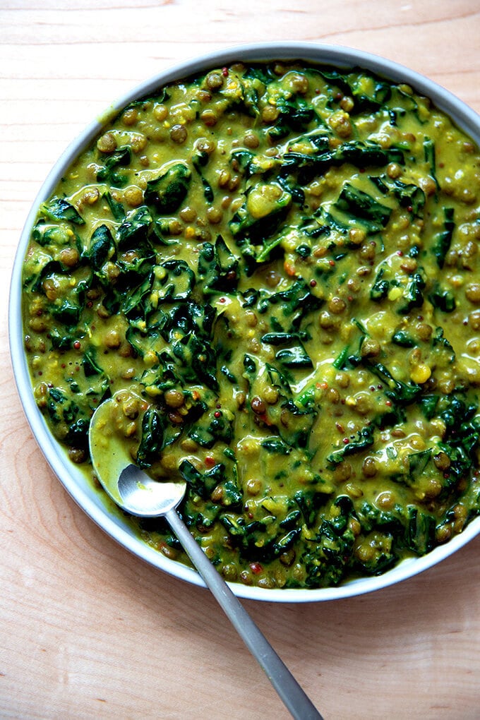 Curried lentils with kale and coconut in a bowl.