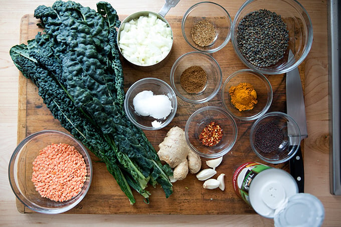 curried lentils with kale and coconut milk ingredients on a board.