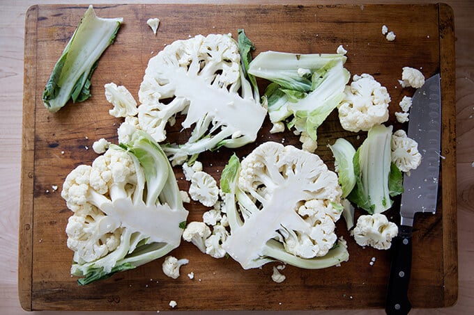 cauliflower cut into steaks on a board