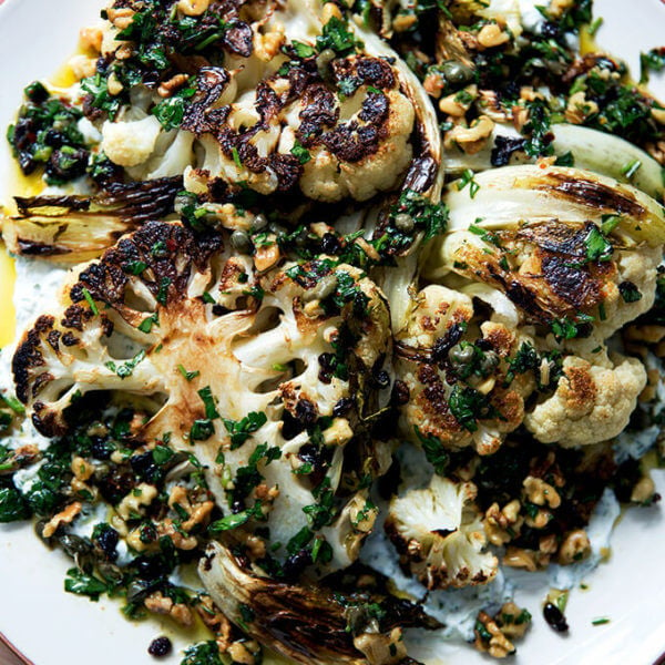 cauliflower steaks with caper-walnut salsa on a platter