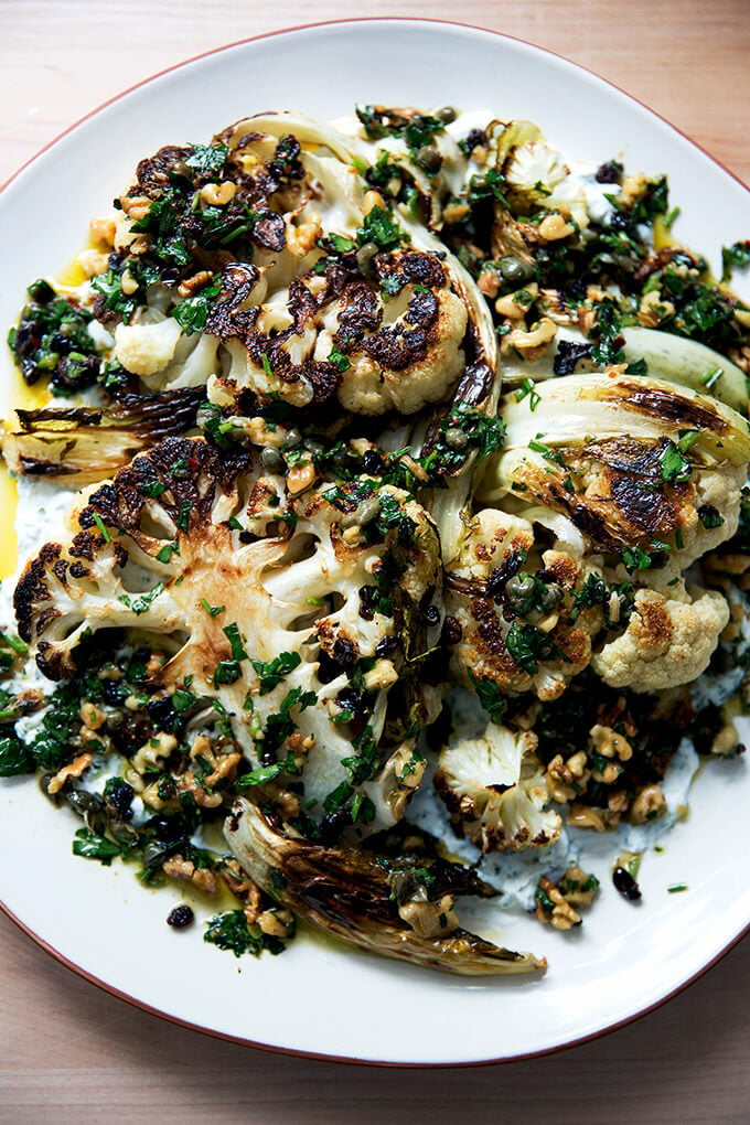 cauliflower steaks with caper-walnut salsa on a platter