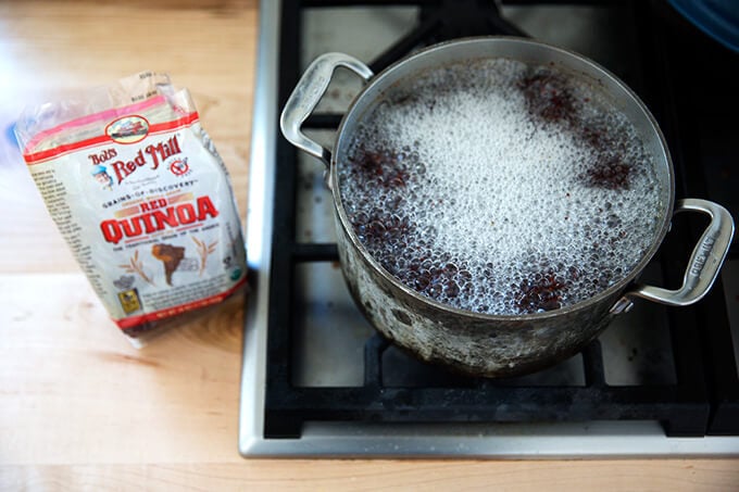 red quinoa boiling in a pot