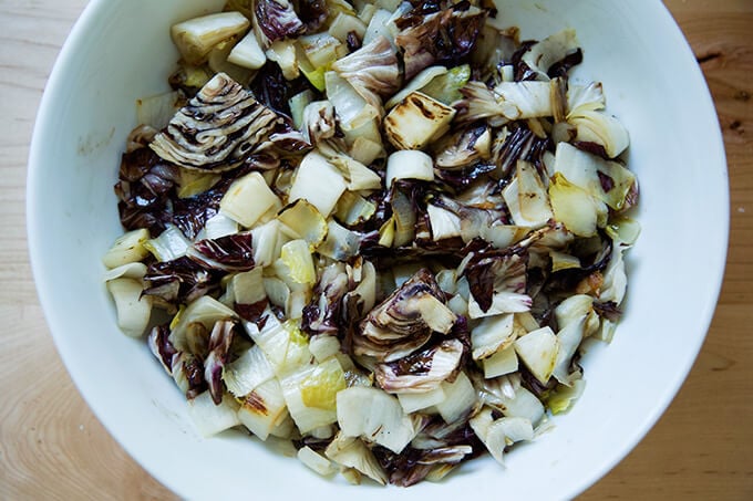 A large bowl of sautéed chicories with chile oil.