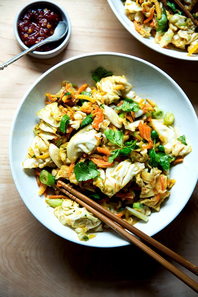 A bowl of chopped Thai salad satay with hot sauce.