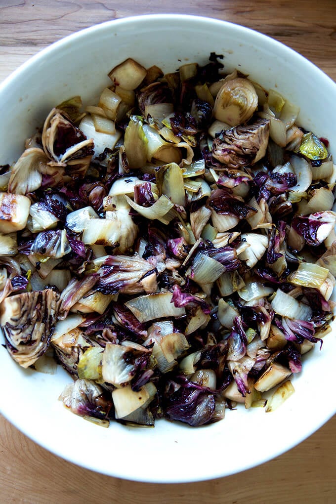 A large bowl of sautéed chicories with garlic, balsamic, and chile oil.