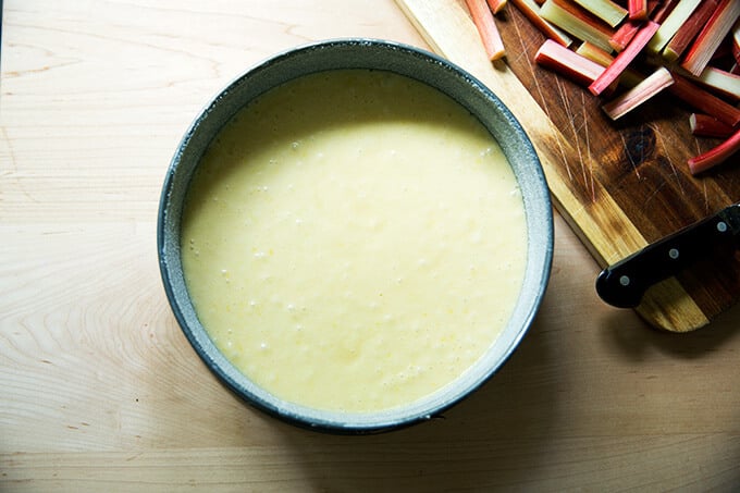 Springform pan filled with batter for rhubarb-custard cake.