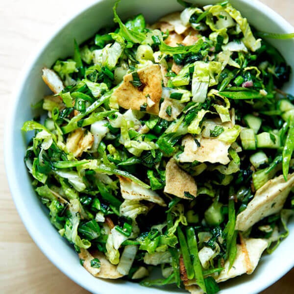 A finished bowl of a spring salad with crispy pita and fattoush dressing ready to be eaten.