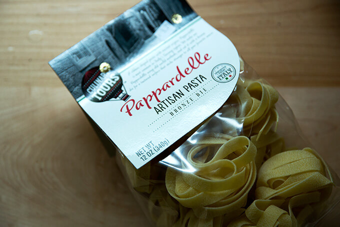 A bag of dried pappardelle pasta.