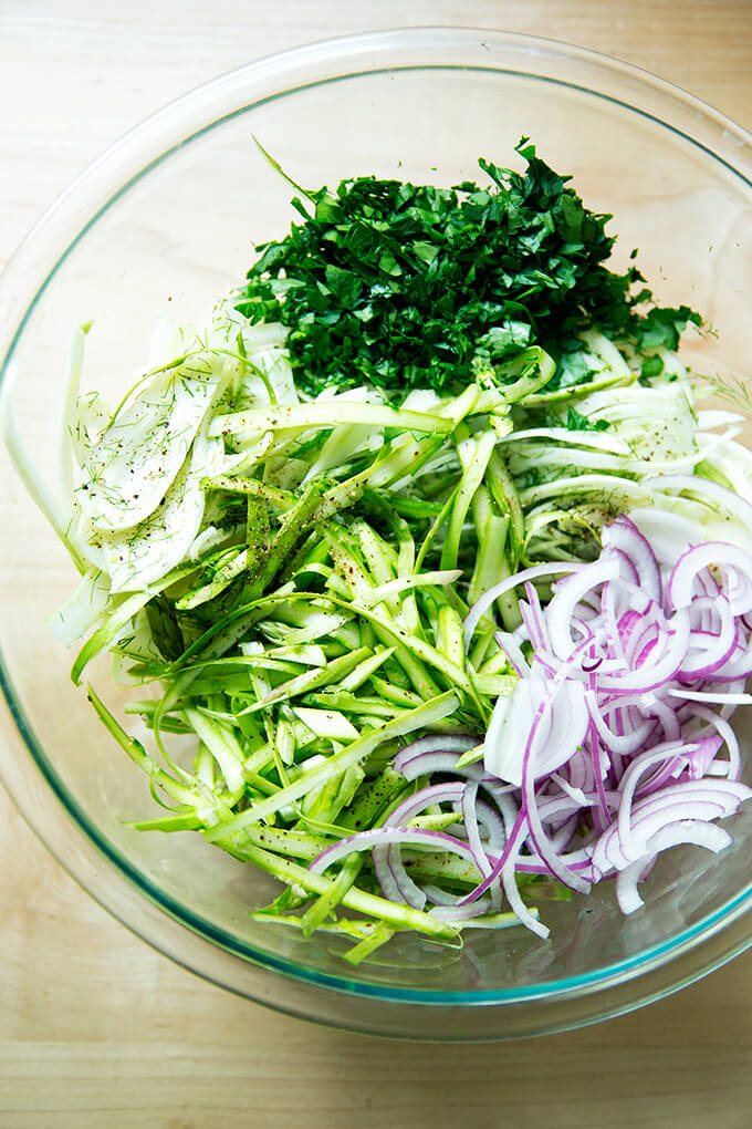 A bowl of shaved fennel, asparagus, parsley, and onion.