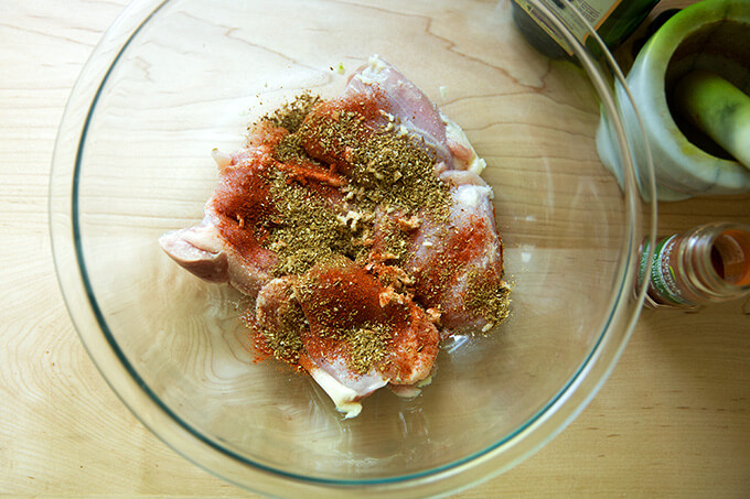raw chicken thighs covered with salt, smoked paprika, toasted cumin and coriander