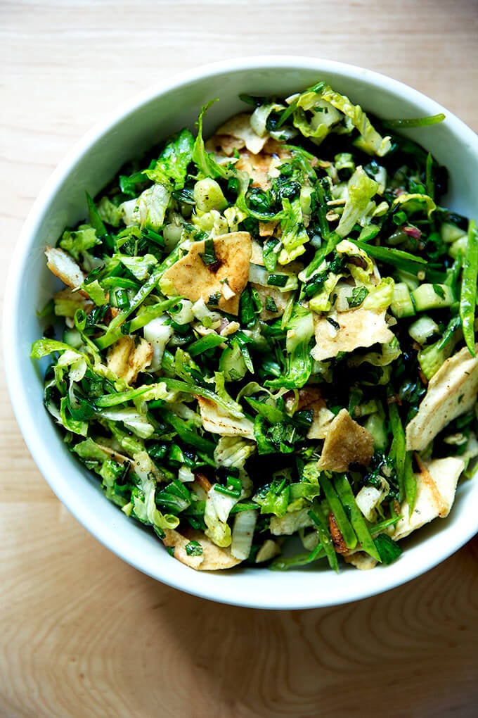 A finished bowl of a spring salad with crispy pita and fattoush dressing. 