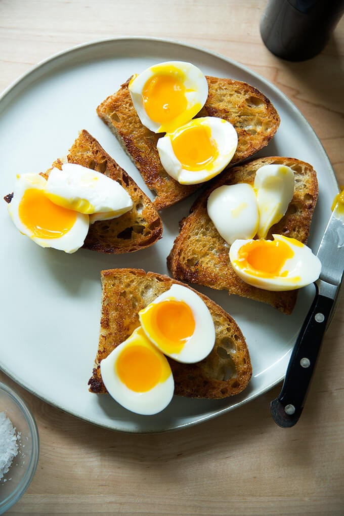 Halved soft-boiled eggs on vinaigrette toast.