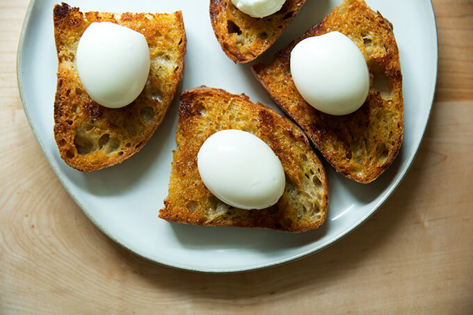 A plate of soft-boiled eggs on vinaigrette toast.