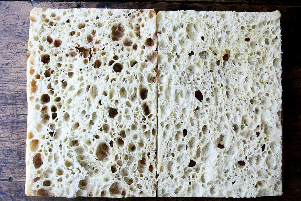 A sheet pan with halved focaccia