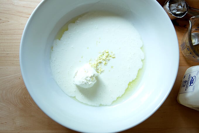 A bowl with the ingredients to make the buttermilk dressing.