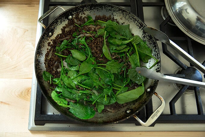 mixing in the spinach