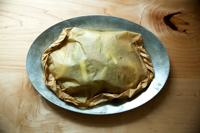 A sizzle pan of fish en papillote ready for the oven.