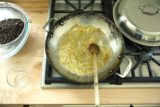 A skillet with sautéed onions and white balsamic.