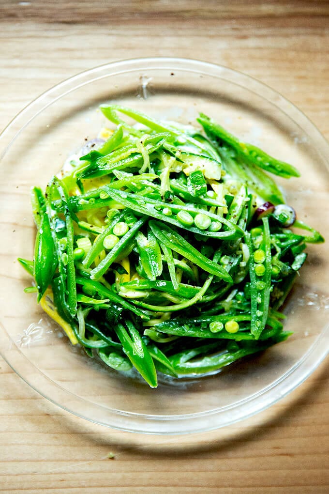 A plate of sugar snap pea salad with buttermilk dressing. 