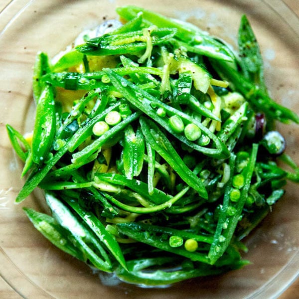 A plate of sugar snap pea salad with buttermilk dressing.