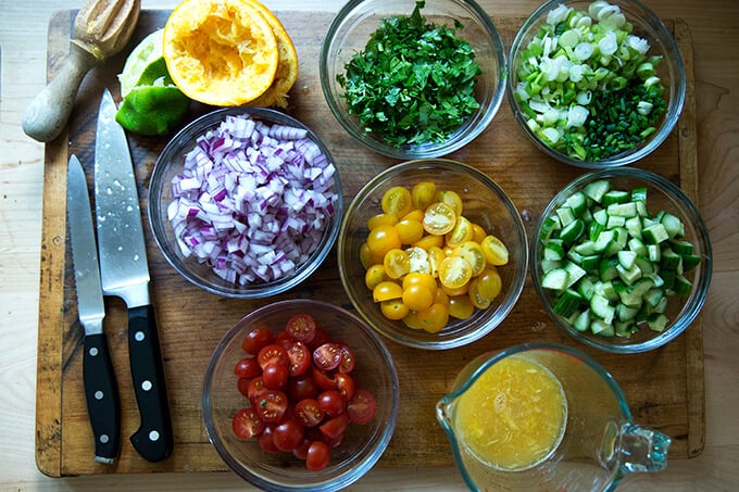 A board with ingredients for tabbouleh, all prepped.