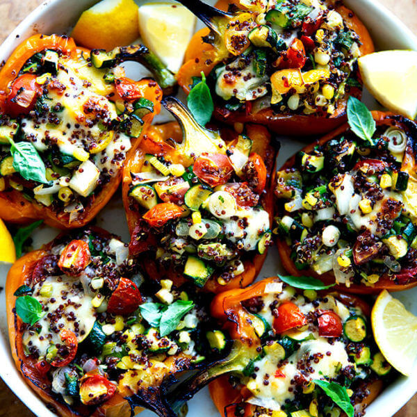 Roasted bell peppers stuffed with quinoa and sautéed corn, zucchini, and tomatoes.
