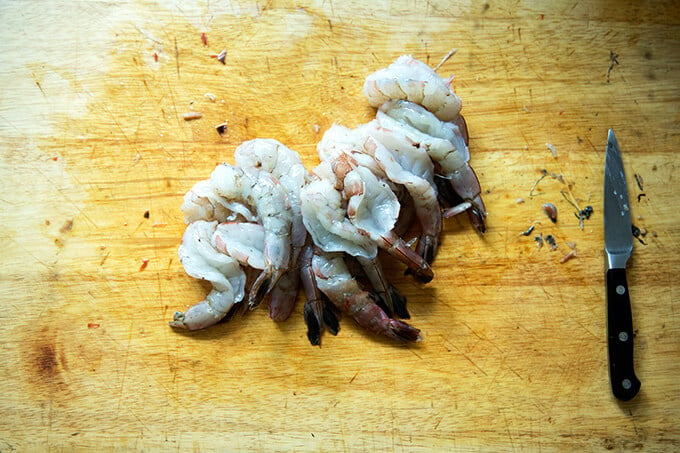 A board with butterflied shrimp. 