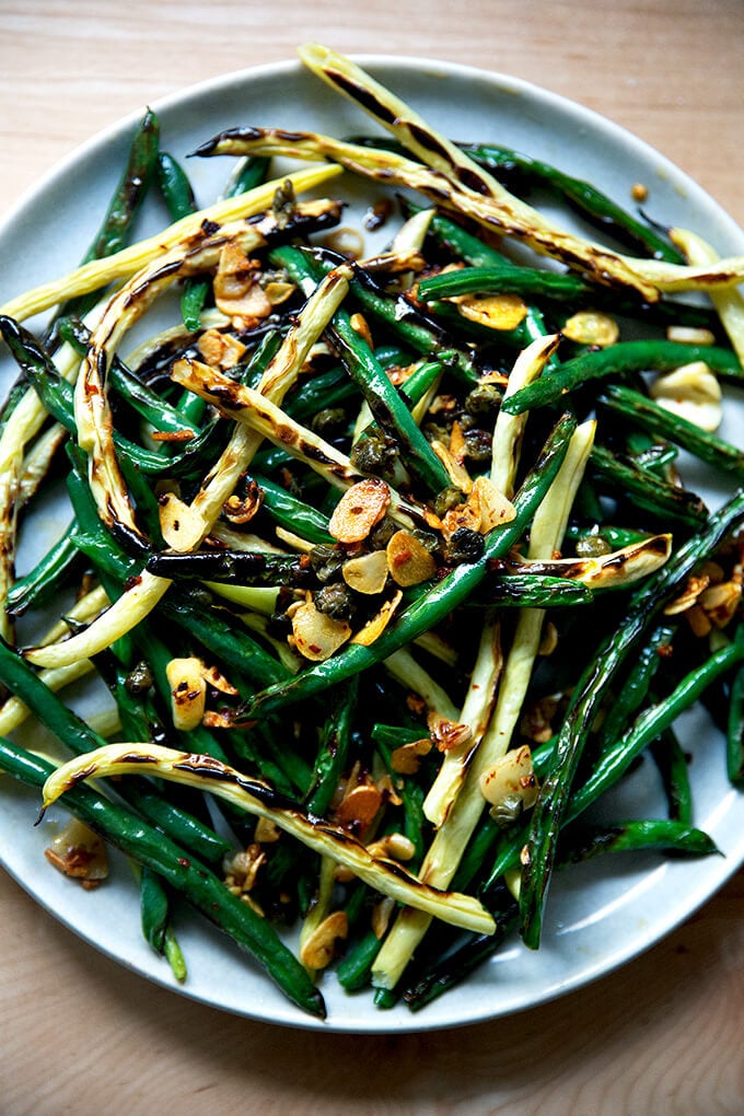 Blistered fresh green beans on a platter. 