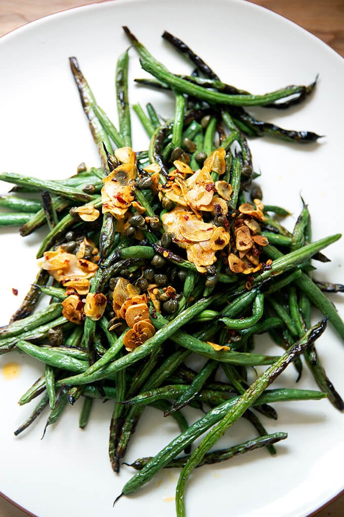 A plate of spicy, blistered green beans with garlic. 