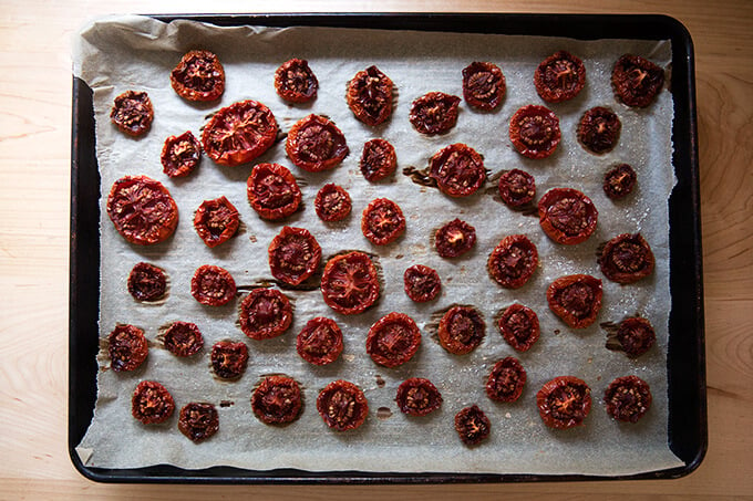 oven-dried tomatoes on a parchment-lined sheet pan