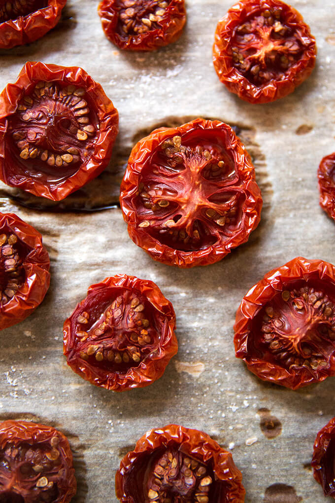 oven-dried tomatoes on a parchment-lined sheet pan