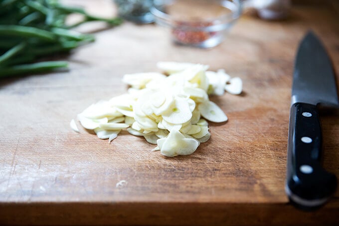 Sliced garlic on a board. 