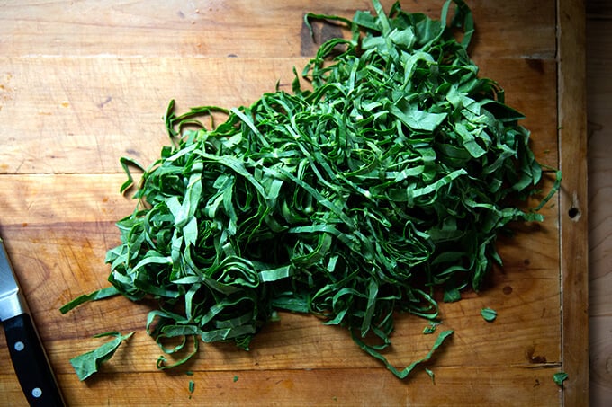 A board with slivered collard greens on top. 