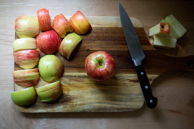 An apple on a cutting board.