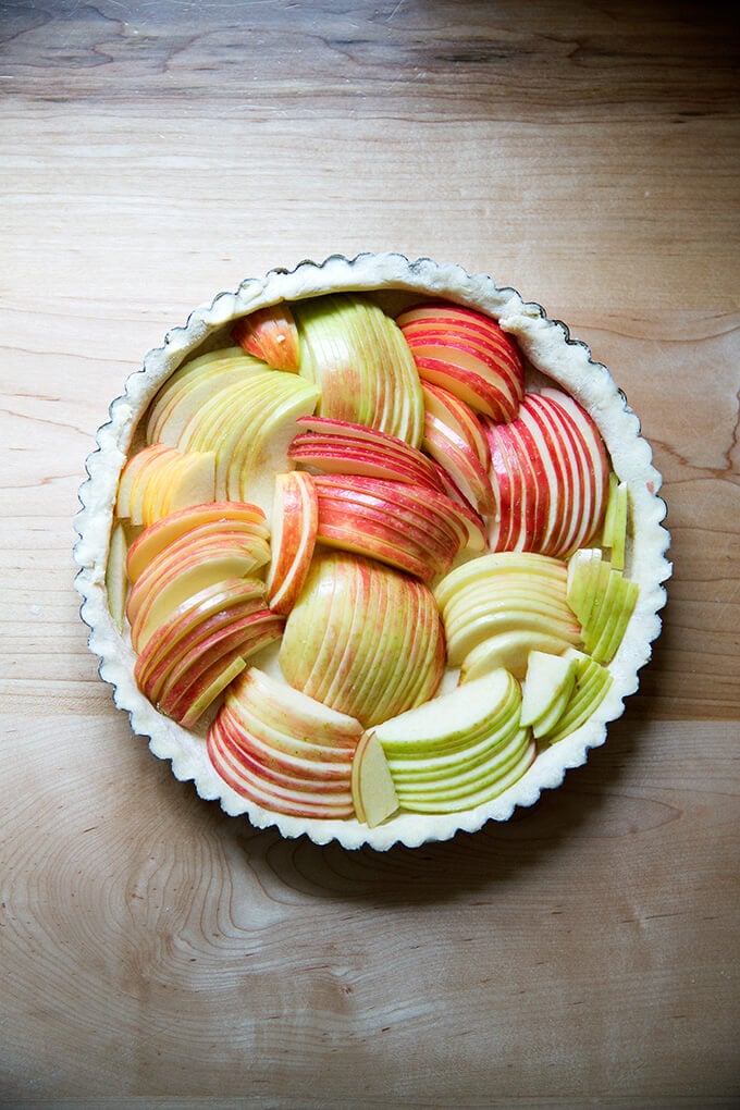 Unbaked French apple tart filled with sliced apples.