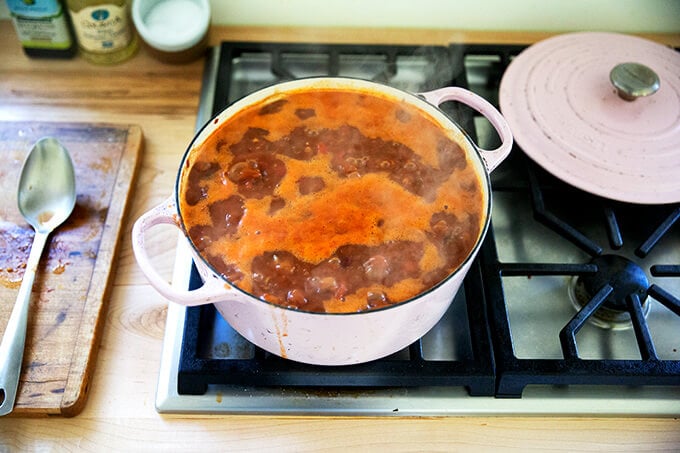 A large pot of vegetarian chili simmering stovetop.