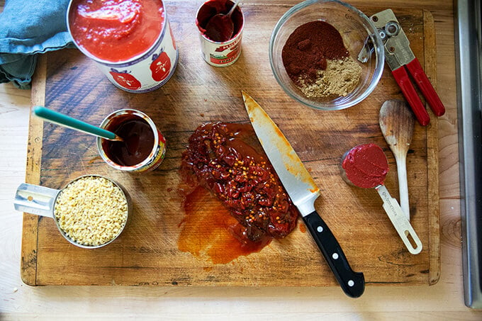 A large board topped with chopped chipotles in adobo sauce.