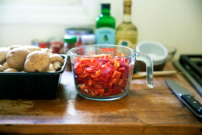 A liquid measure filled with chopped red bell peppers.